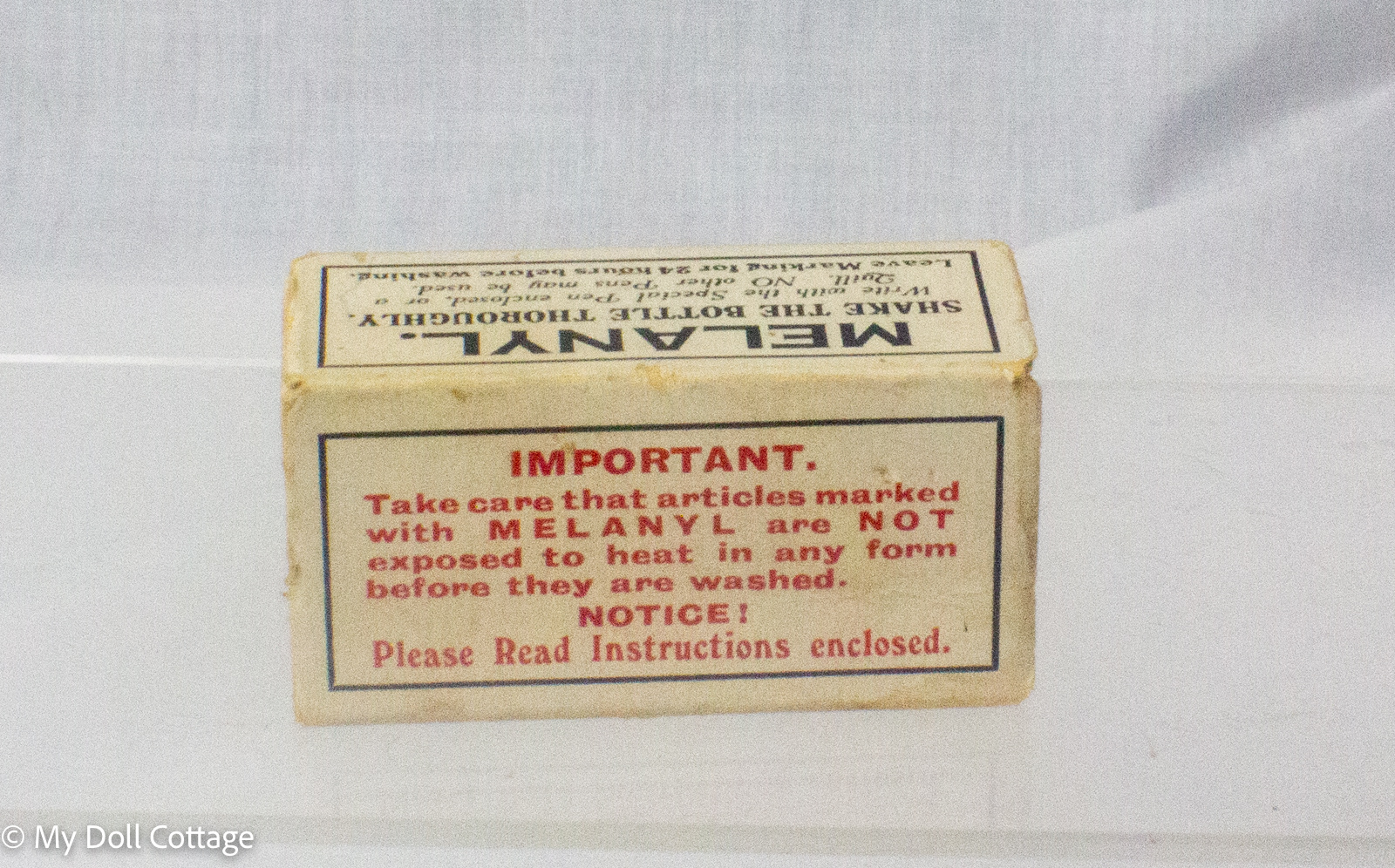 Vintage Melanyl indelible linen marking ink kit in original cardboard box with blue glass ink bottle, pen holder, steel nib and metal linen stretcher, manufactured in England.. Showing Important note