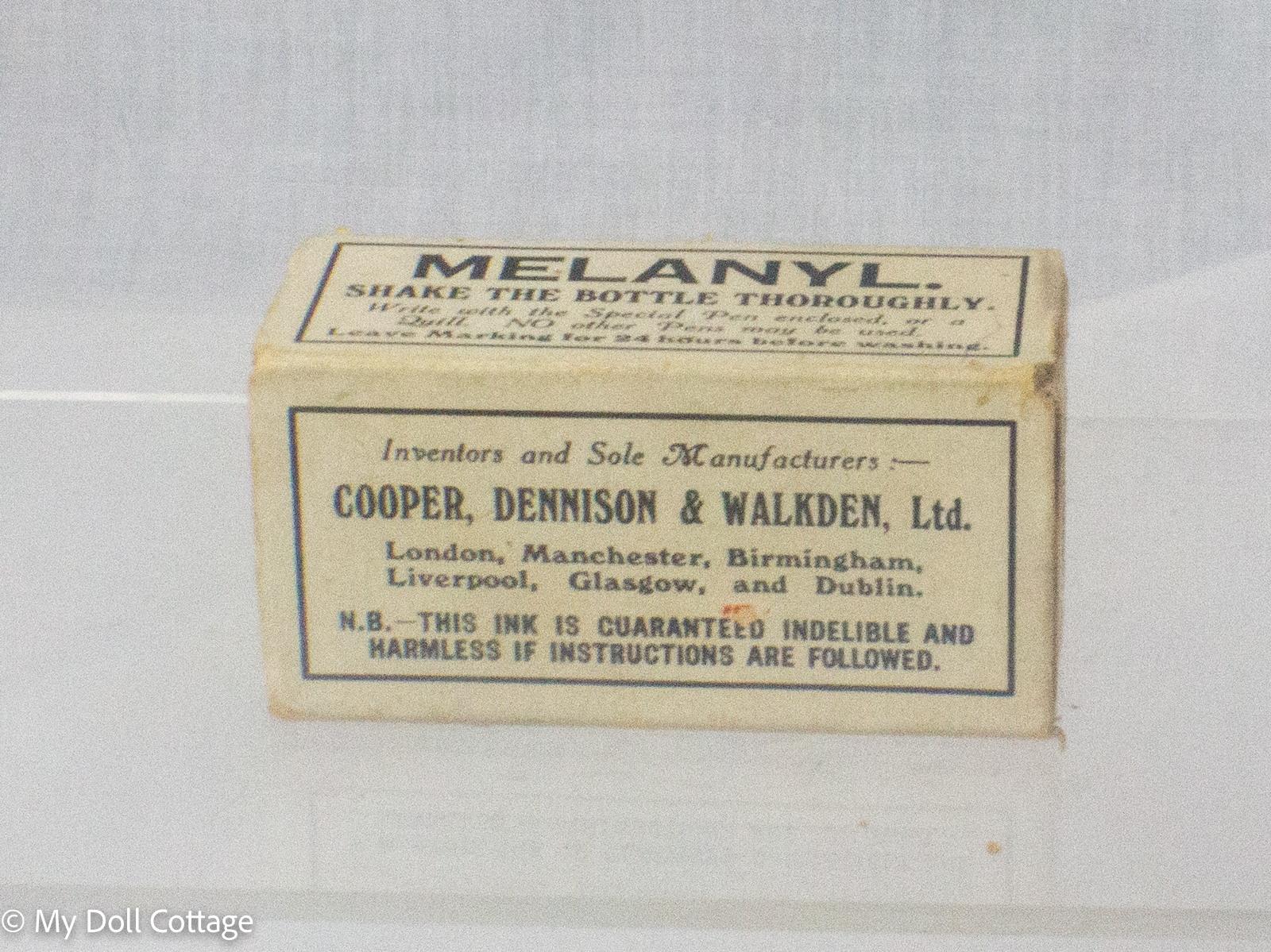 Vintage Melanyl indelible linen marking ink kit in original cardboard box with blue glass ink bottle, pen holder, steel nib and metal linen stretcher, manufactured in England. showing manufacturing information