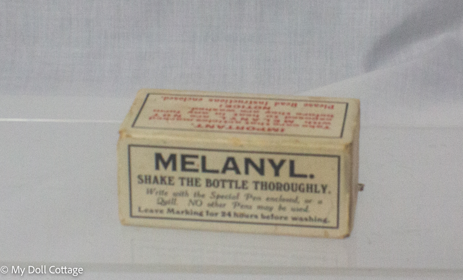 Vintage Melanyl indelible linen marking ink kit in original cardboard box with blue glass ink bottle, pen holder, steel nib and metal linen stretcher, manufactured in England.
