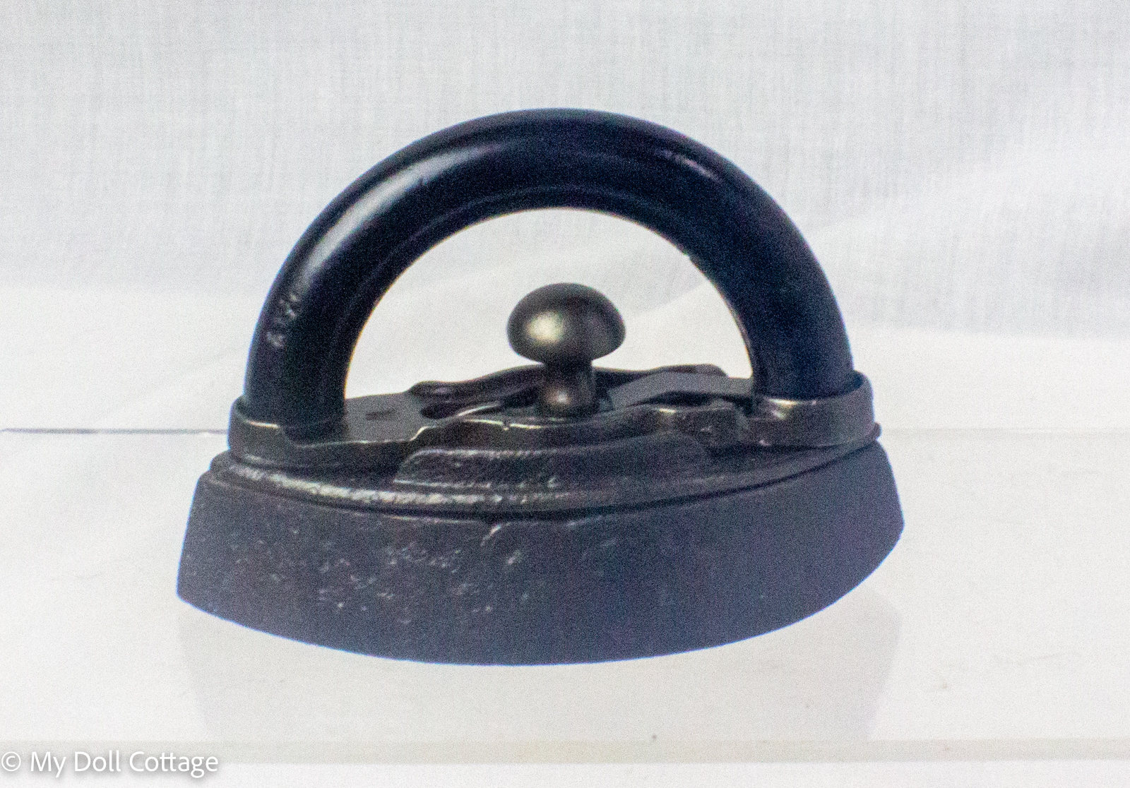 Overall view of the miniature Mrs. Potts style salesman sample iron in excellent original condition.