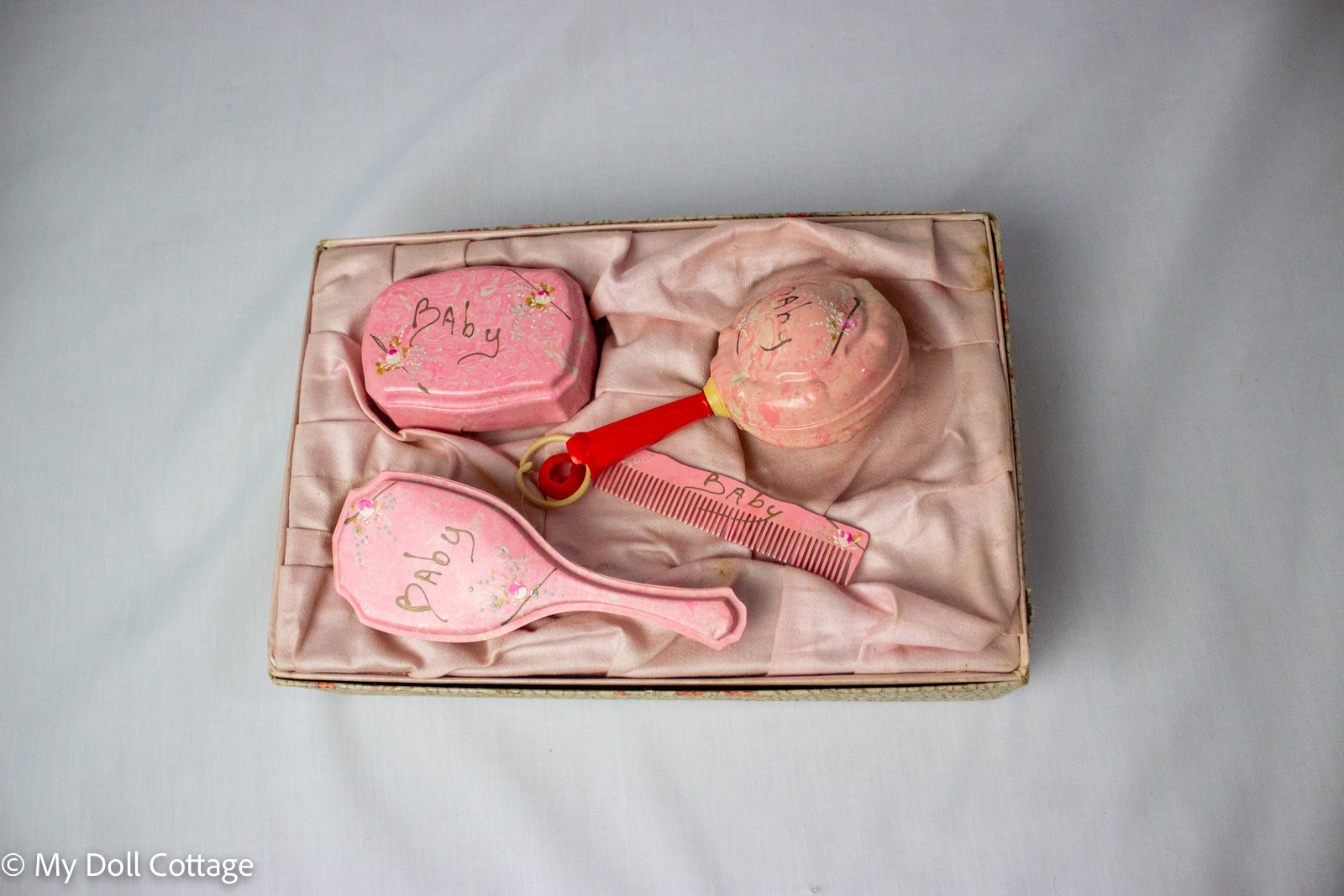 Overhead view of the vanity set arranged in the fitted satin interior.