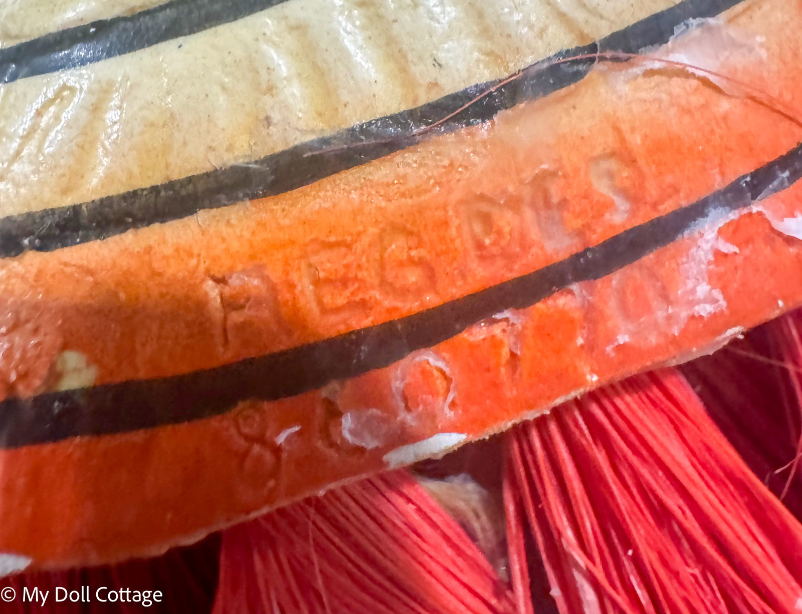 •	Close-up of impressed registration mark on the underside of the largest brush.