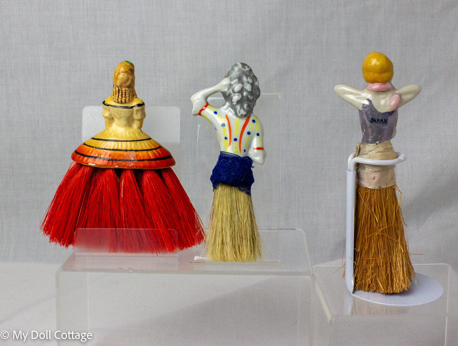 •	Rear view showing painted figures and Japanese mark on one brush.