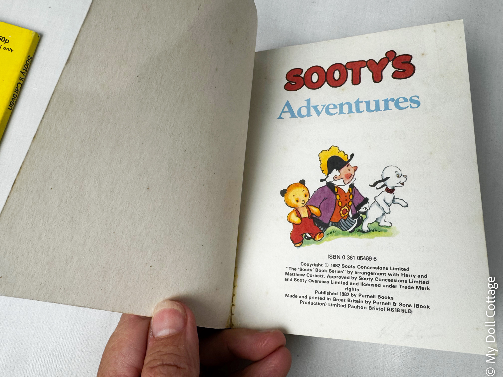 Title page of the 1982 Purnell Playmates Sooty’s Adventures book featuring Sooty, Sweep and a costumed character, with publication details below.