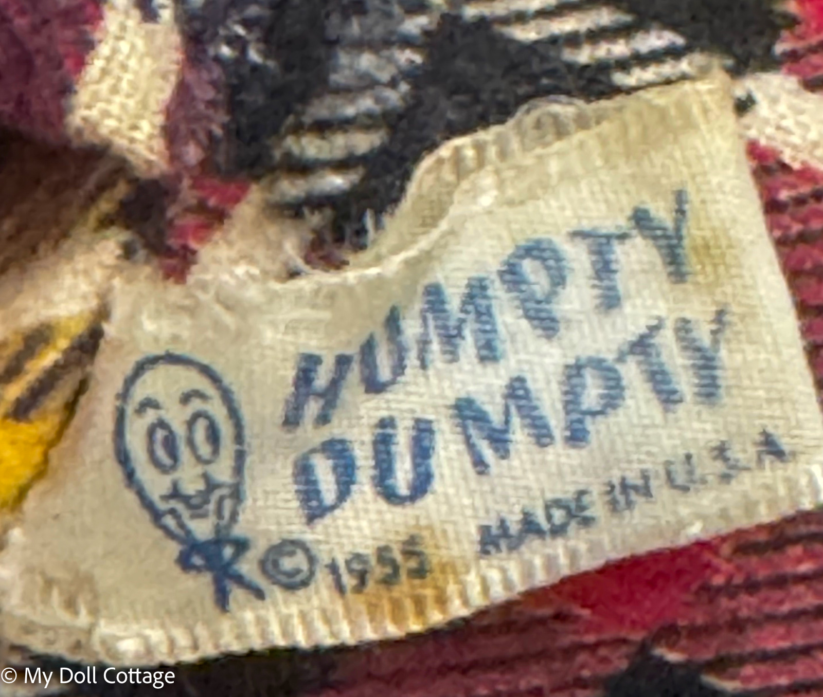 Close-up of the original fabric tag on the 1955 Knickerbocker Humpty Dumpty stuffed toy, marked “Humpty Dumpty”, copyright 1955 and Made in U.S.A.