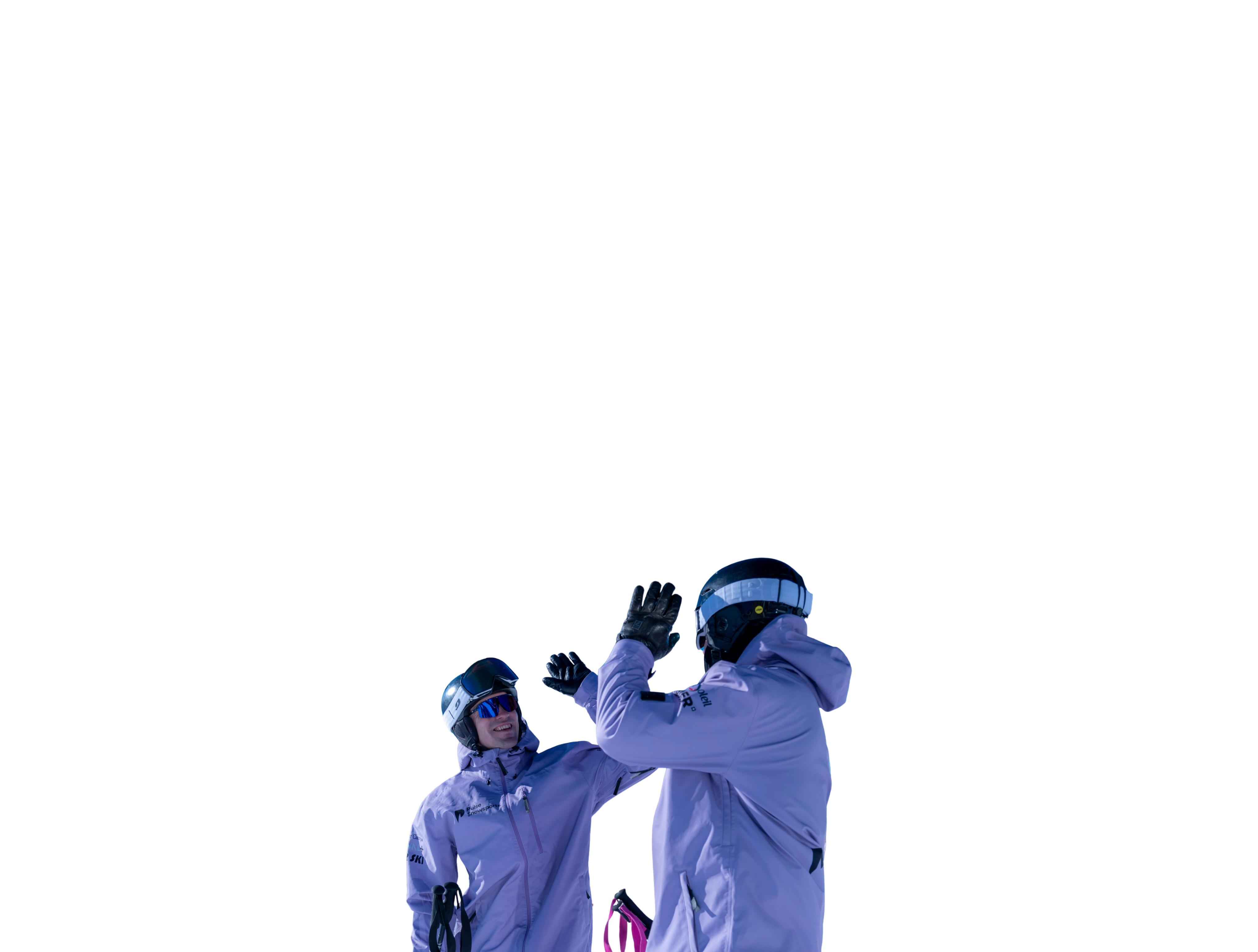 Two skiers in purple jackets and helmets giving a high-five.