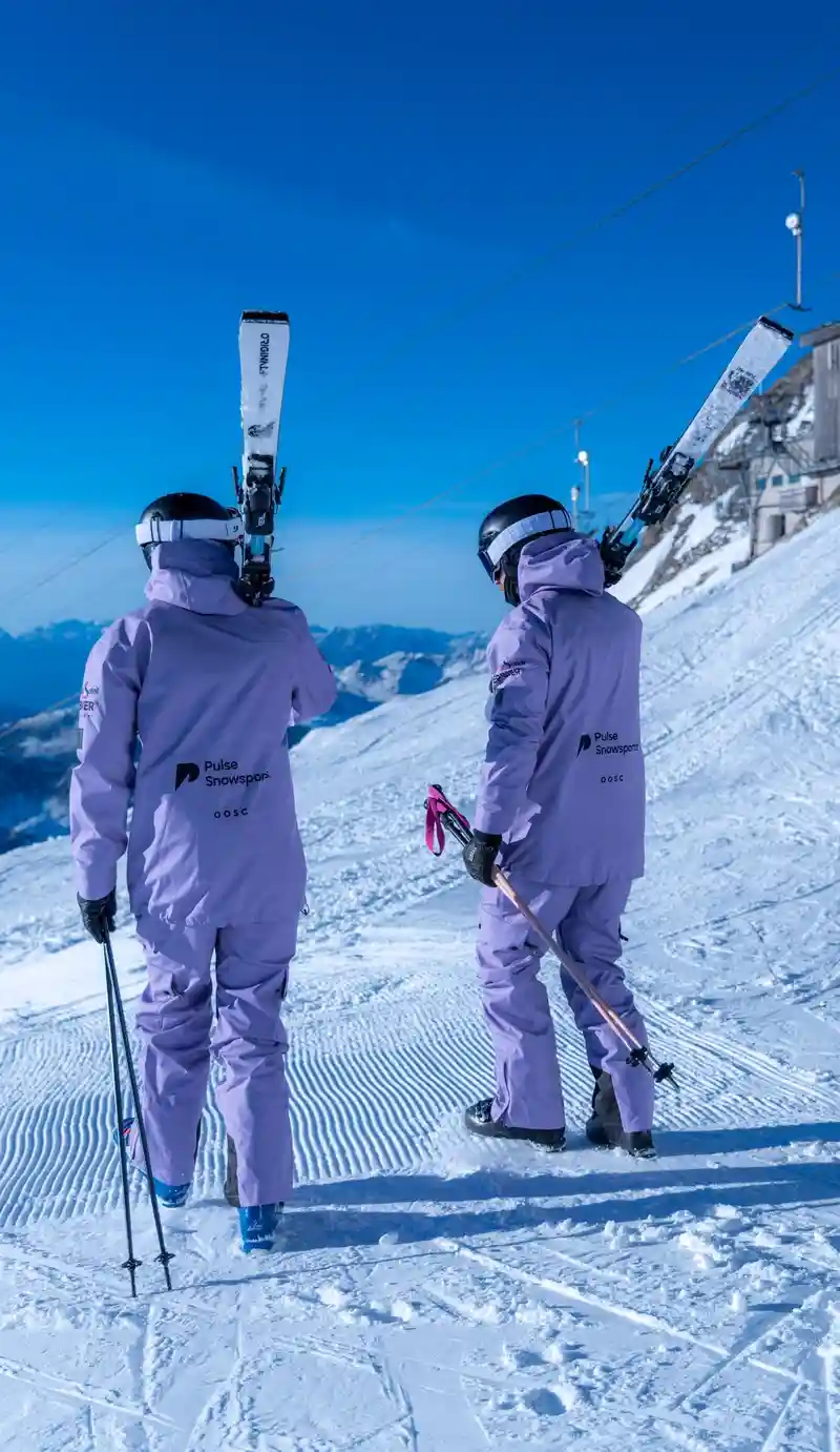 Pulse instructors carrying skis