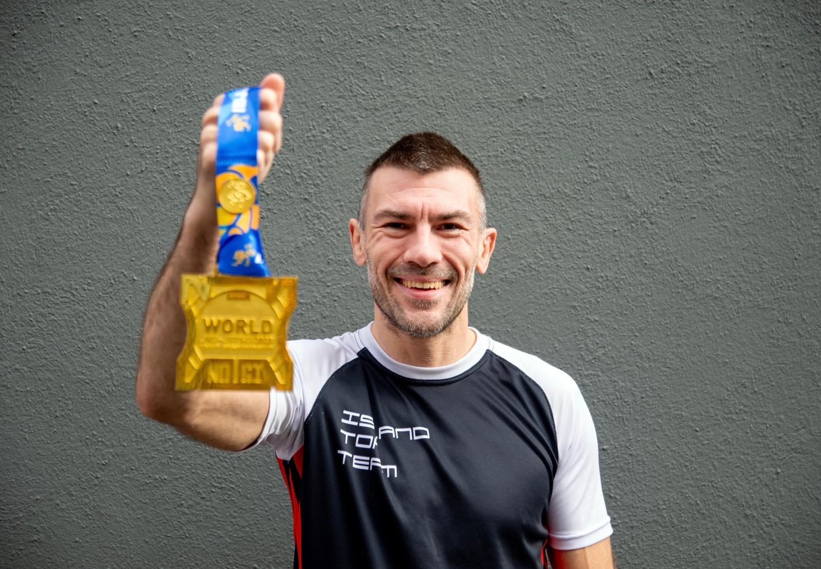 Rob Biernacki holding a gold medal at No Gi Worlds