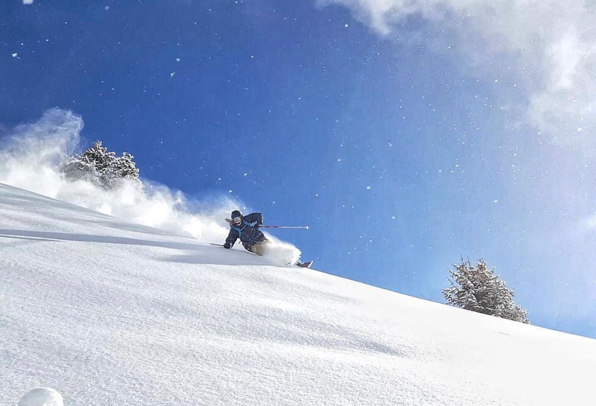 Anthony Whitfield skiing fresh powder during his career as a professional ski instructor in Verbier.