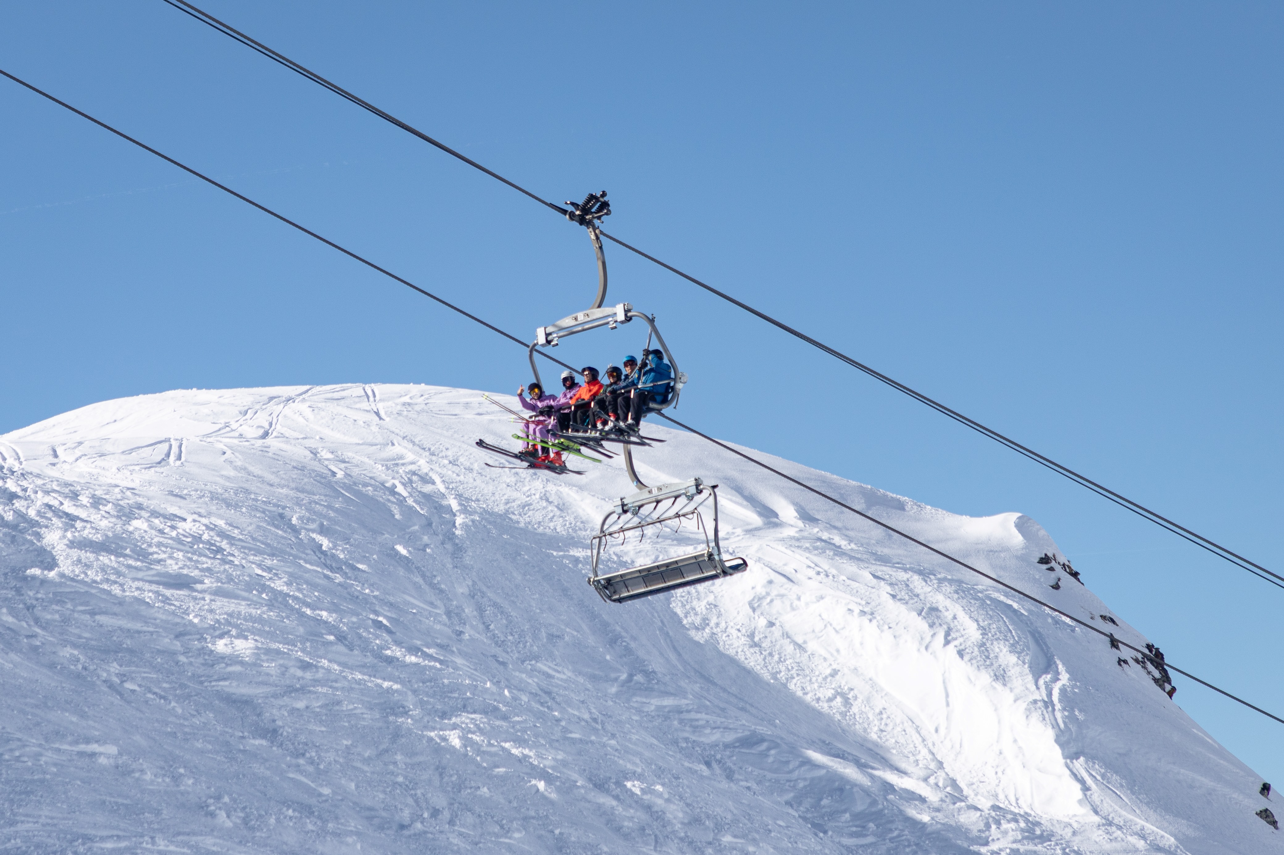 Pulse Snowsports instructor trainees travelling on a chairlift during an instructor training session in Verbier.