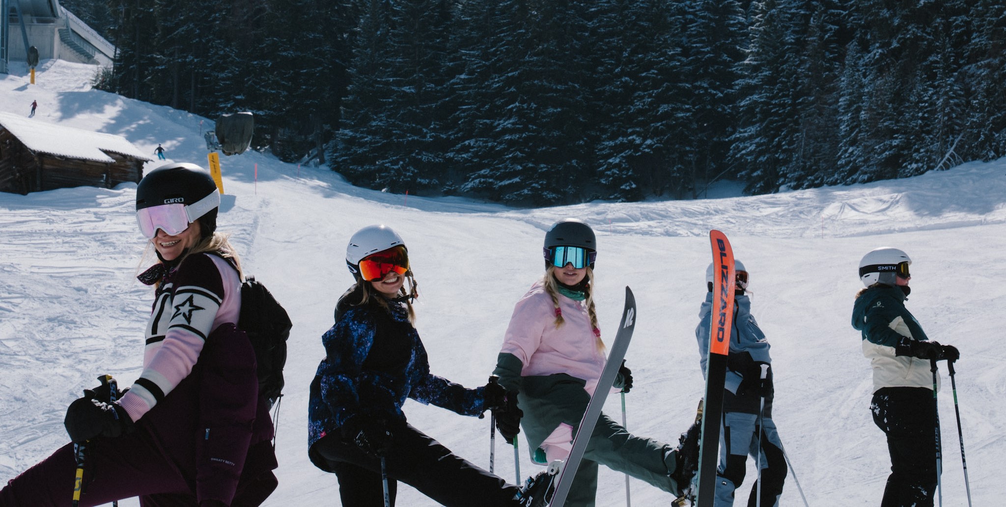 Group of friends enjoying their first ski season together in the mountains, smiling on the slopes during a day of skiing.