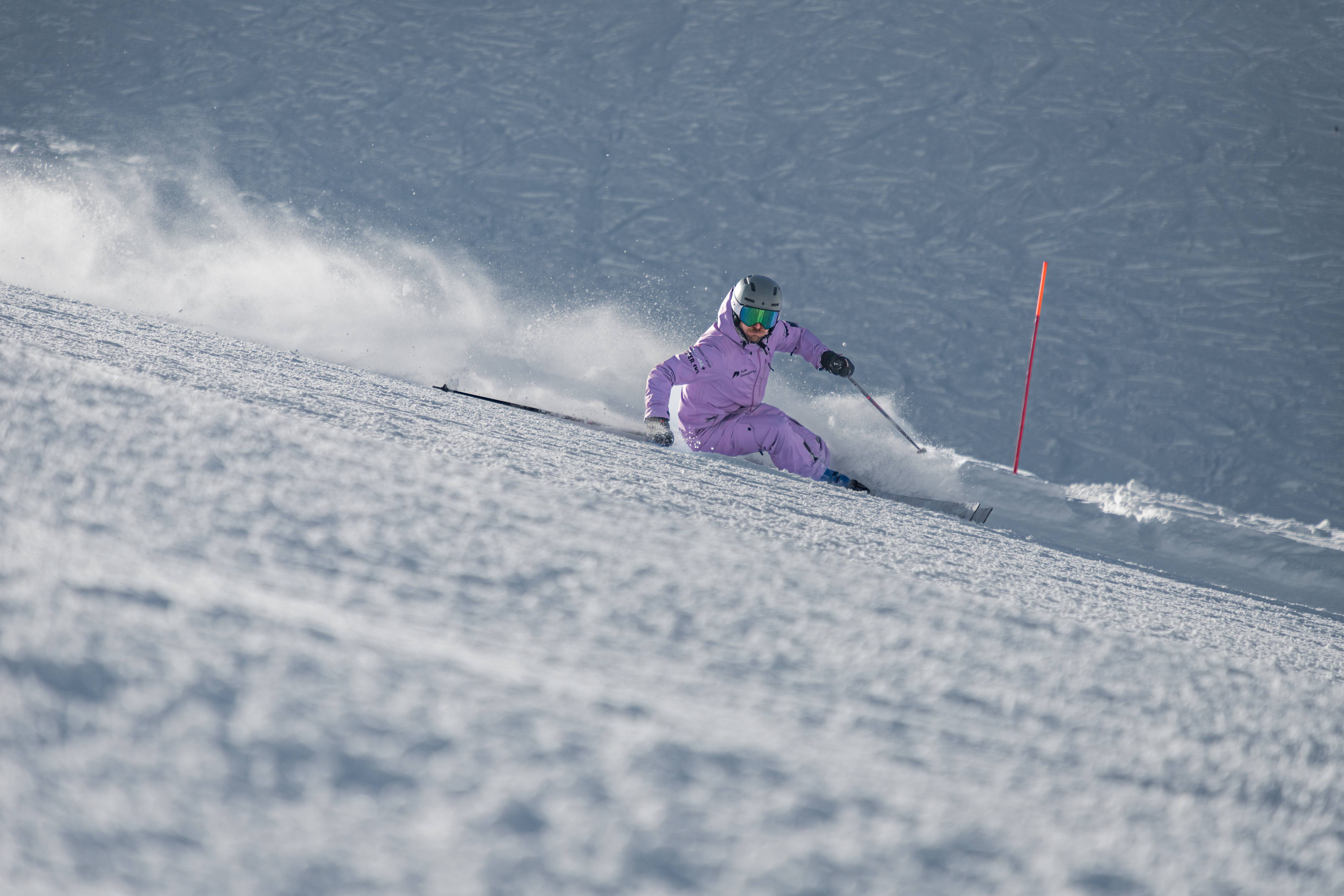 Sam Goodlass carving powerful turns on a groomed piste in Verbier, Switzerland.