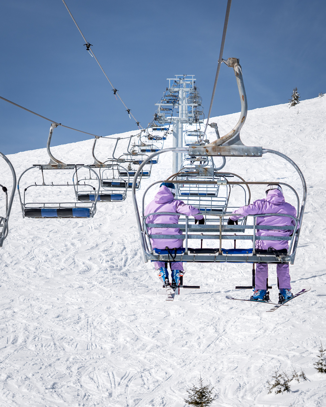 Chairlift carrying skiers above the slopes in Verbier, Switzerland.