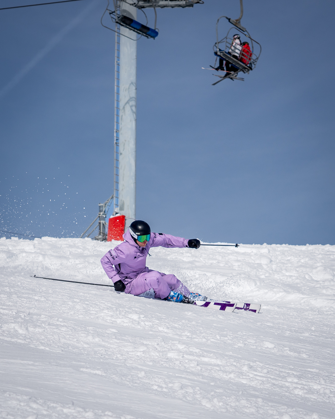 Skier carving powerful turns on a perfectly groomed piste in the Portes du Soleil. Scenic
