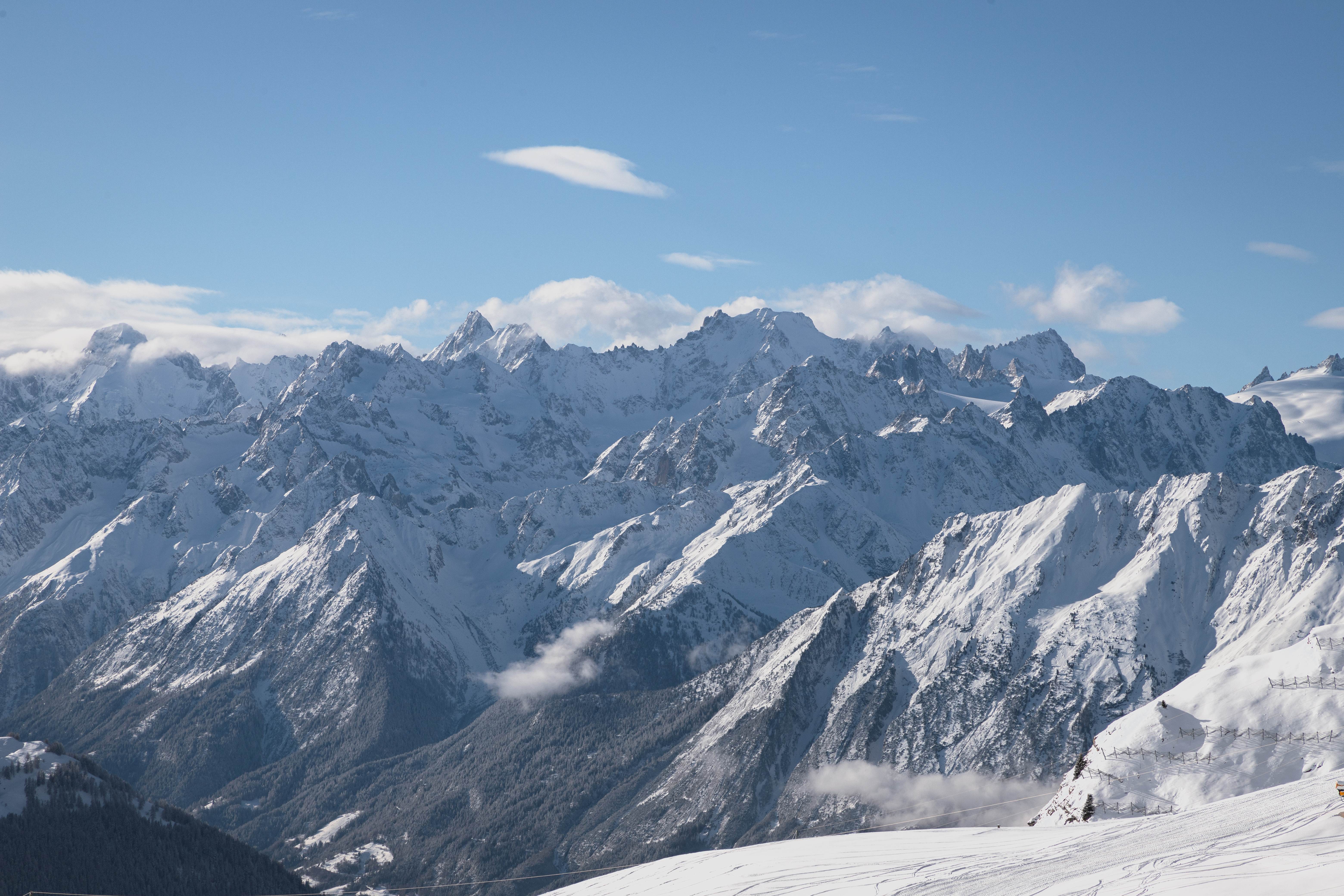 Panoramic view across the snow-covered mountains of Verbier and the 4 Vallées on a clear winter's day.