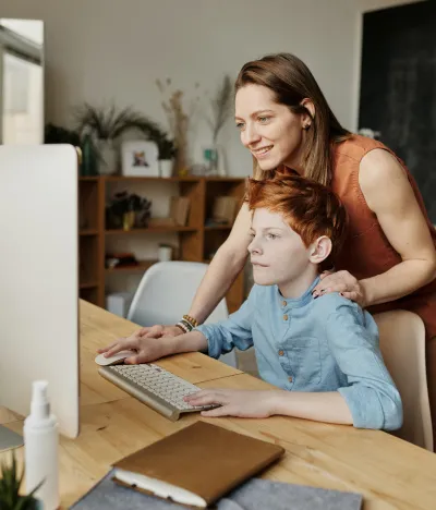 Mother and child work on the computer