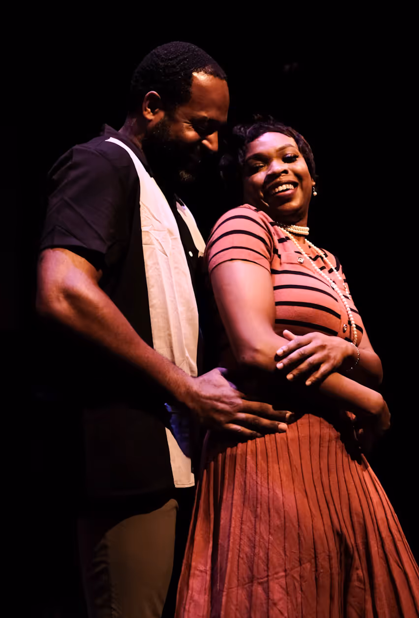 Two actors share a joyful moment on stage at Actors Theatre of Louisville, portraying love in Louisville plays.