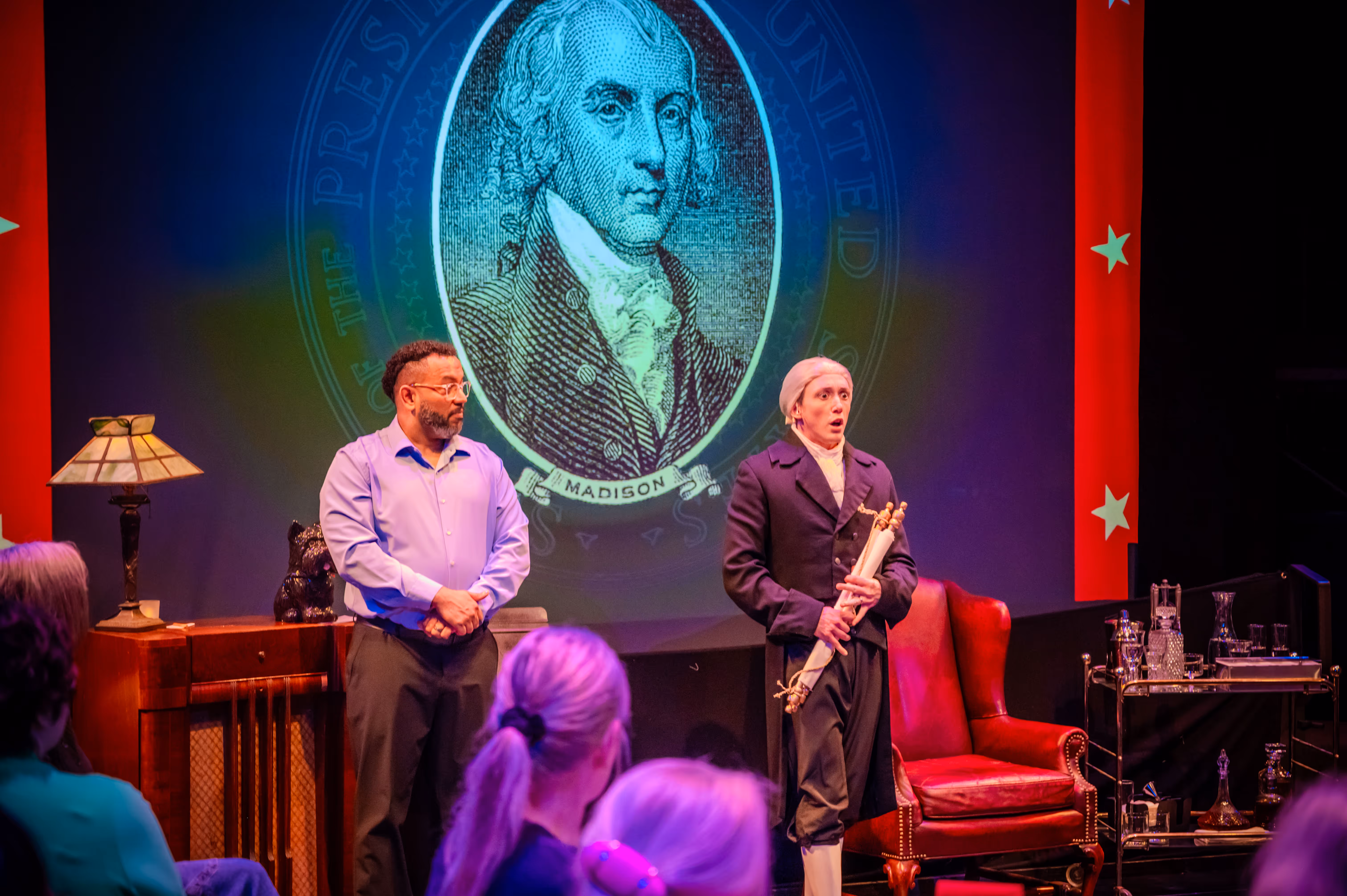 Actors perform historical scene at Actors Theatre of Louisville with James Madison graphic projected behind.