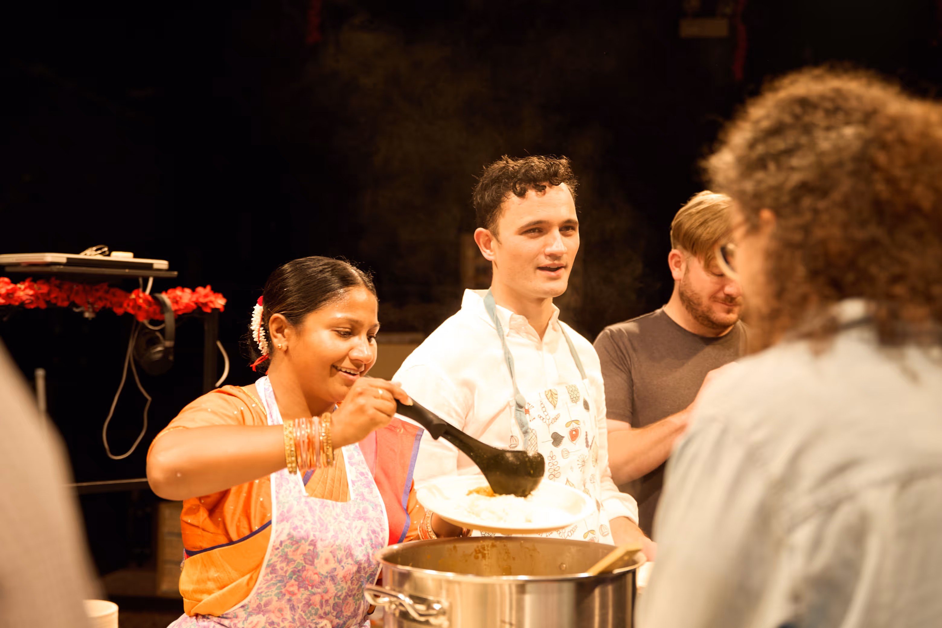 Performers serve food during immersive show at Actors Theatre of Louisville, blending culture and theater.