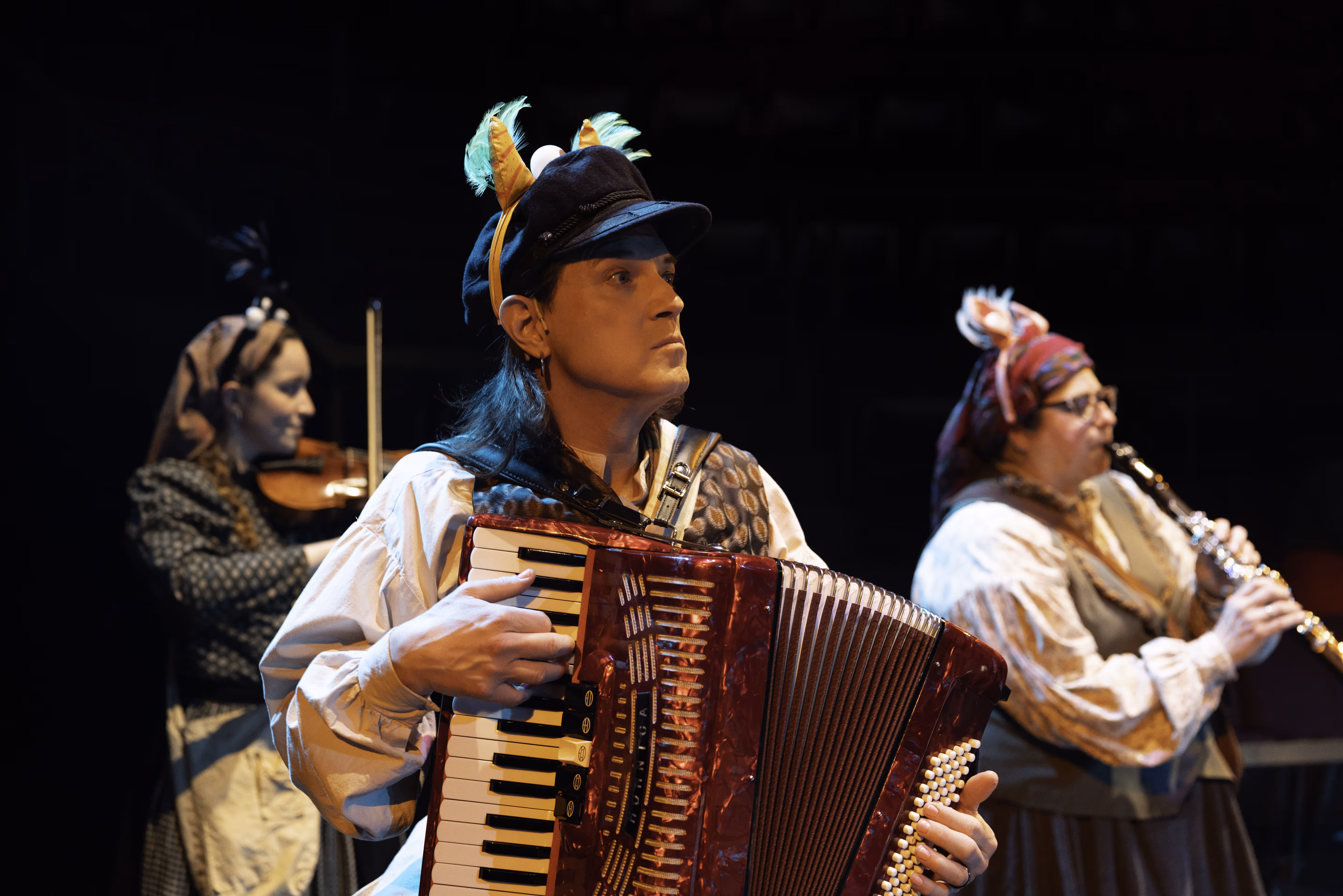 Musicians in costume perform live on stage at Actors Theatre of Louisville, enriching Louisville performing arts.