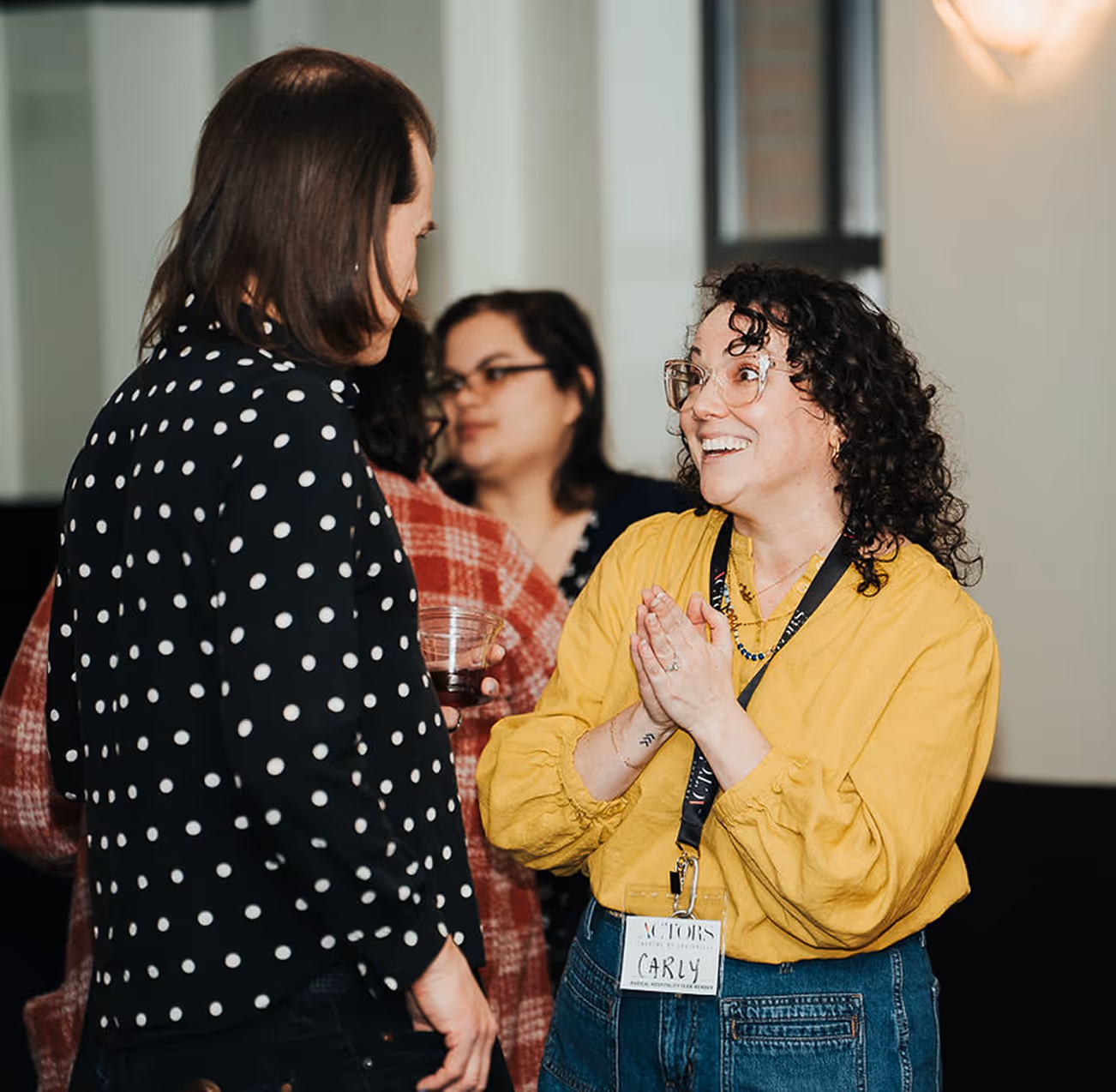Volunteer smiles while chatting at Actors Theatre of Louisville, supporting community in Louisville theater.