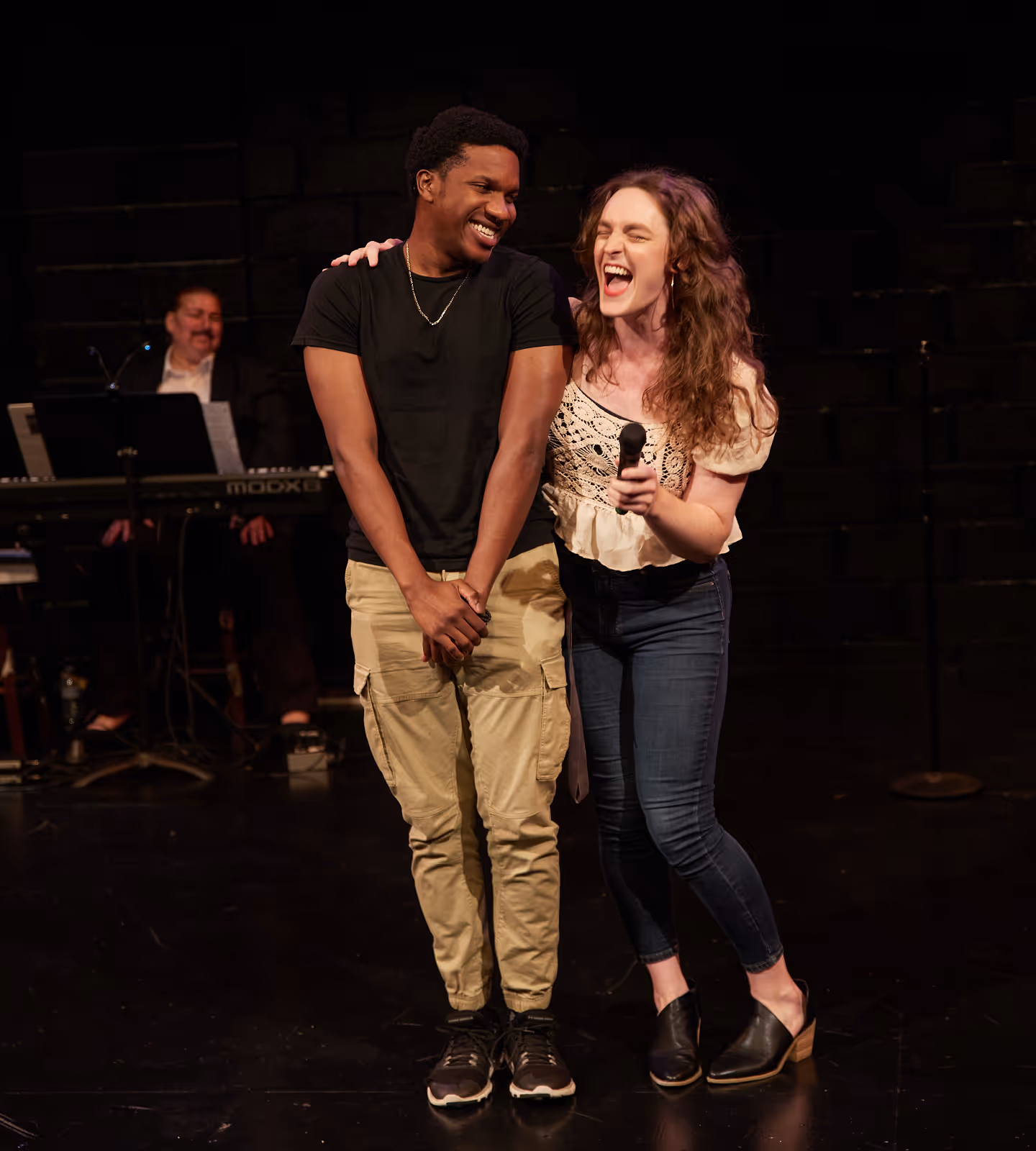 Two performers laugh on stage at Actors Theatre, celebrating community and joy in Louisville theater.