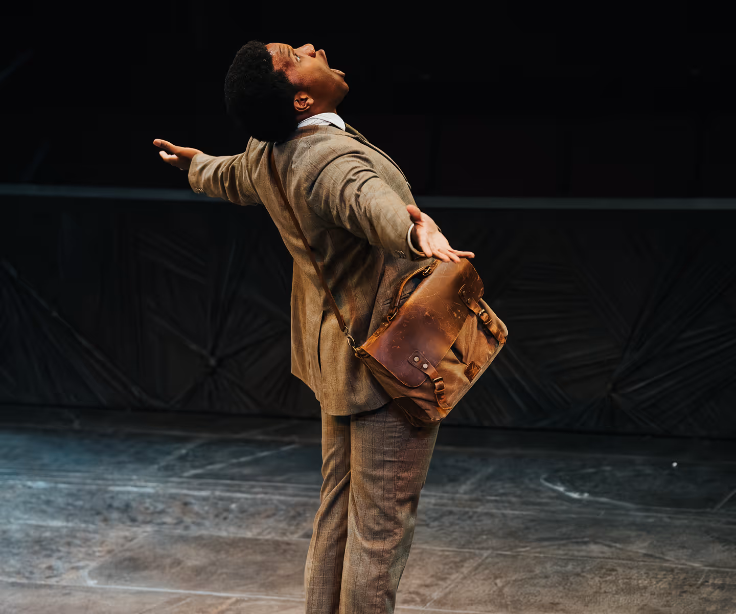 Actor in mid-performance at Actors Theatre of Louisville, expressing emotion on an empty stage.