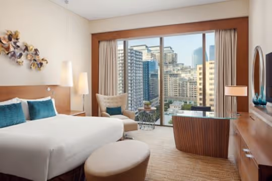 King bed, desk, armchair, view of city