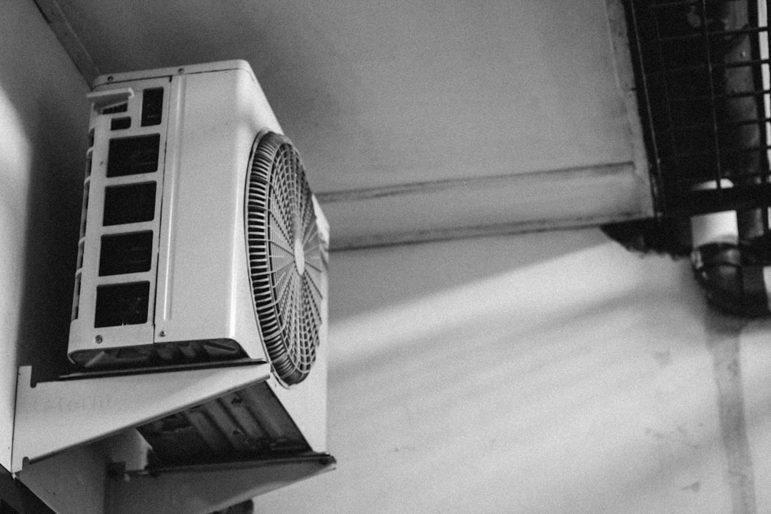 A standard wall-mounted AC unit struggling in a hot server room