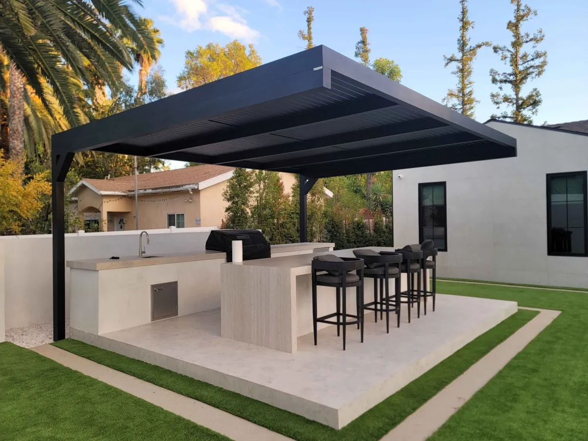 Custom pergola with built-in outdoor kitchen and lighting