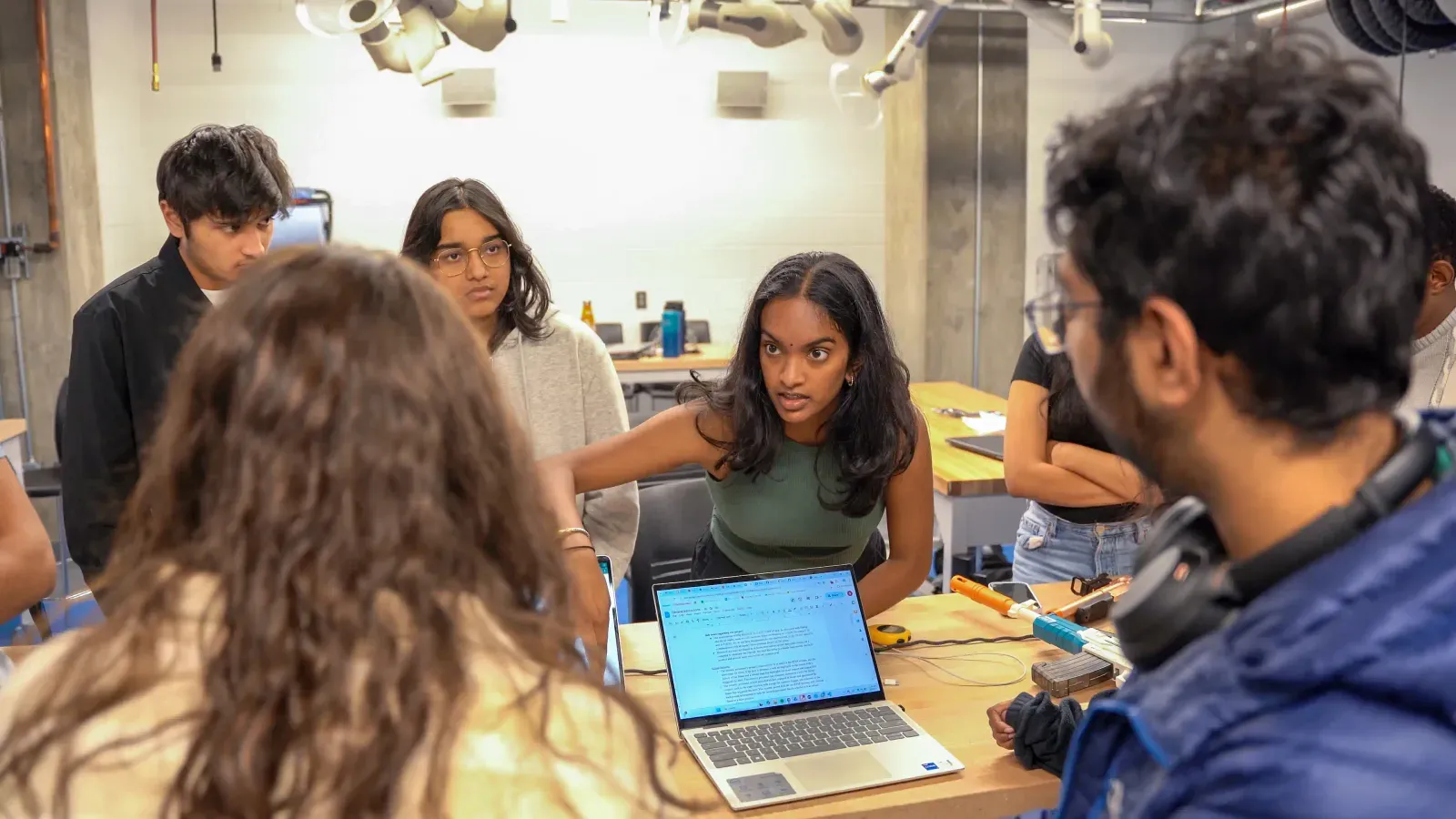 xFoundry students working together around a laptop
