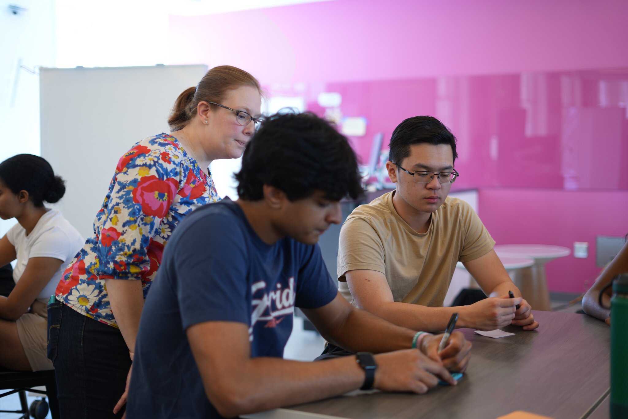xFoundry students working together around a laptop