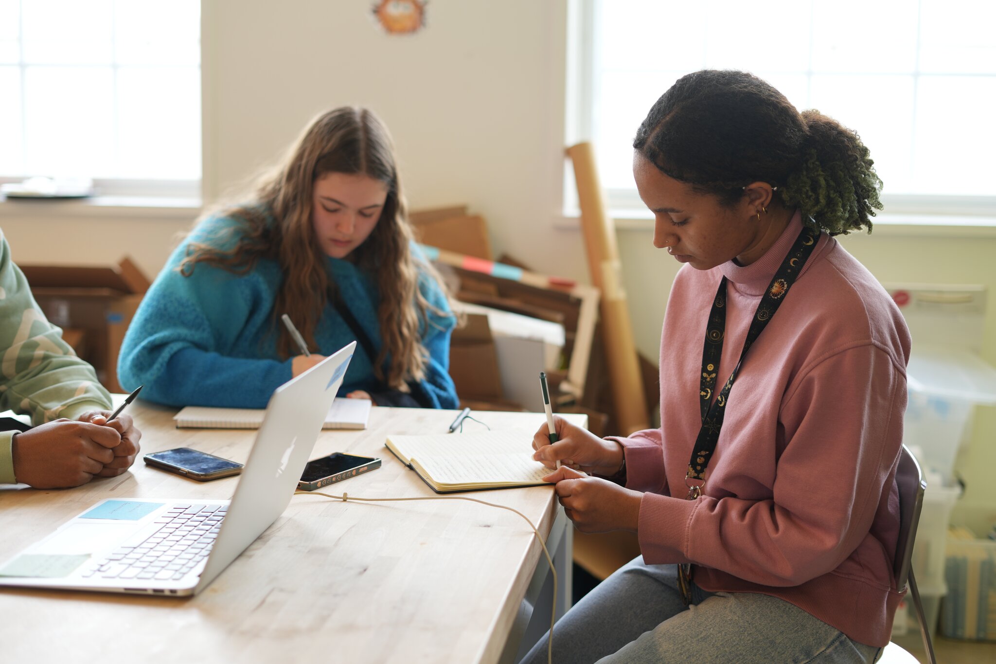 xFoundry students working together around a laptop