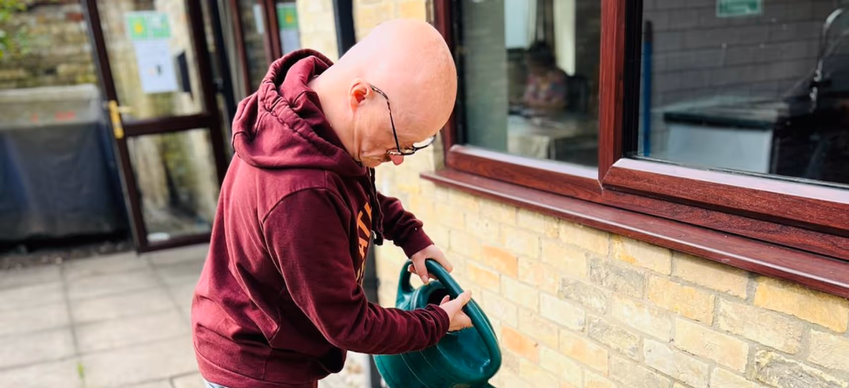 Service user watering plants