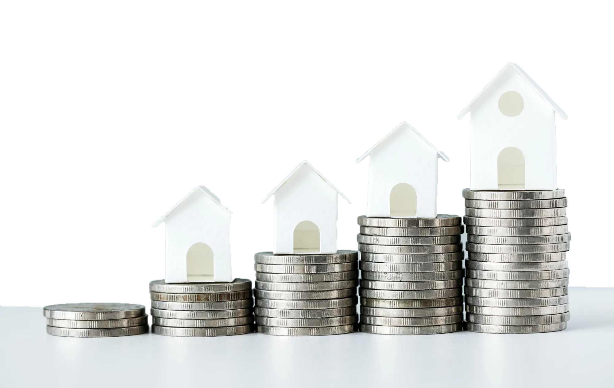 Stacks of silver coins with white paper house models on top, increasing in height from left to right.