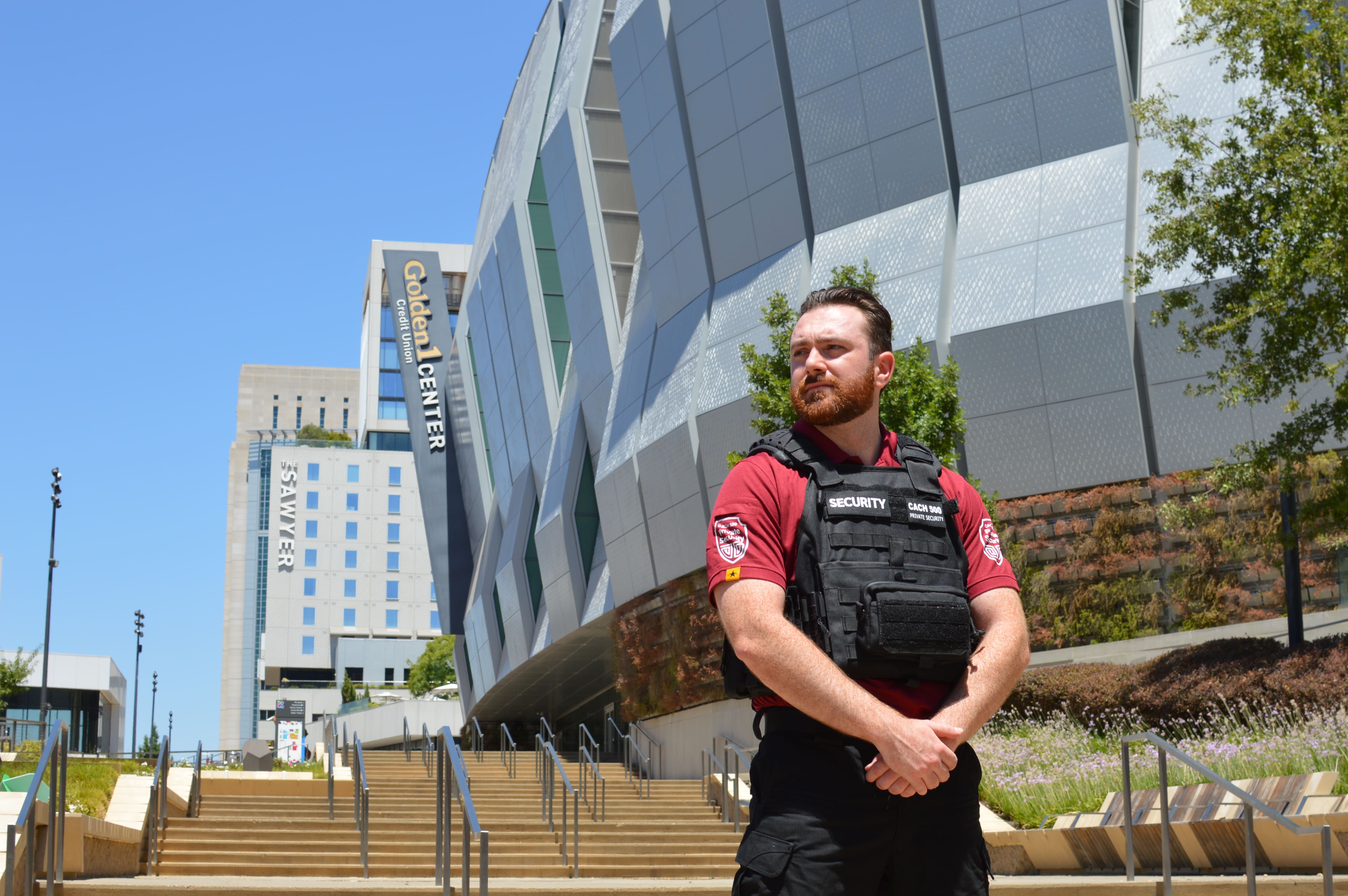 Security guard standing in front of the Golden 1 Center in Sacramento, CA