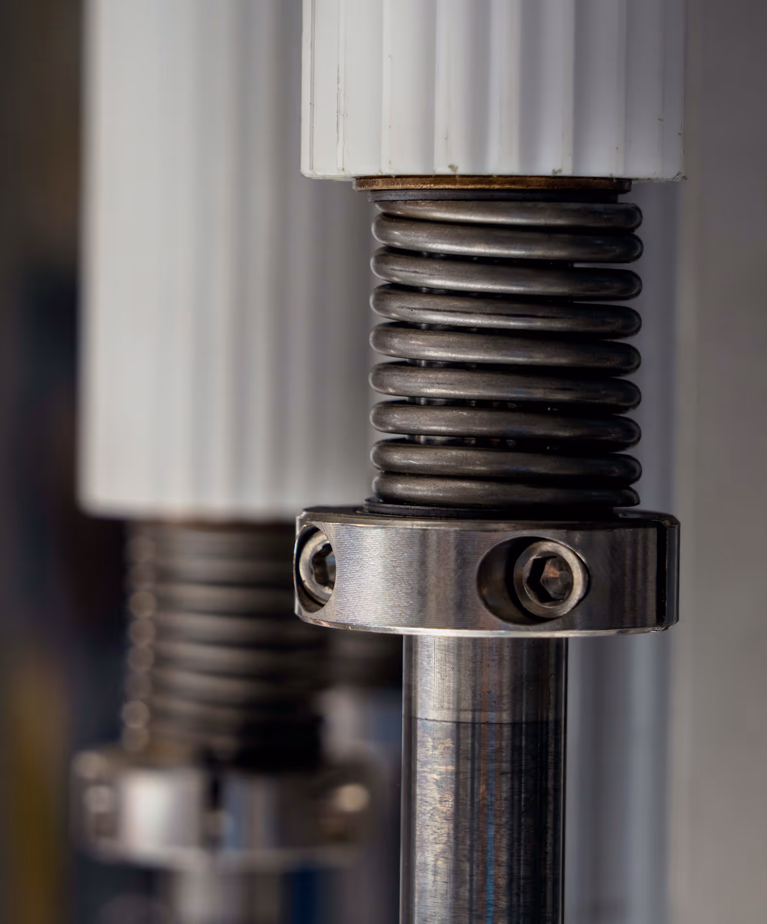A close up of a metal spring with a white background.