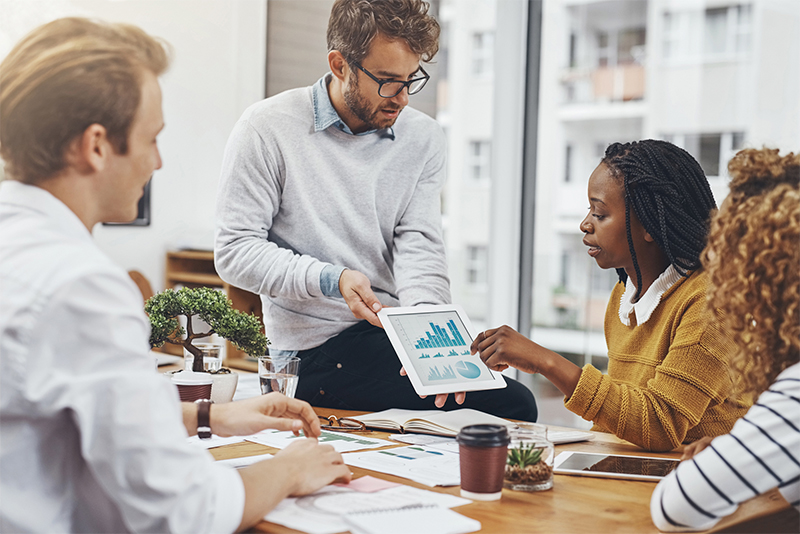 Business team reviewing charts on a tablet