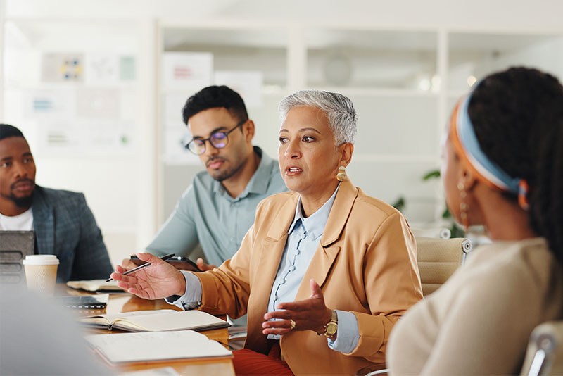 four professionals in meeting room