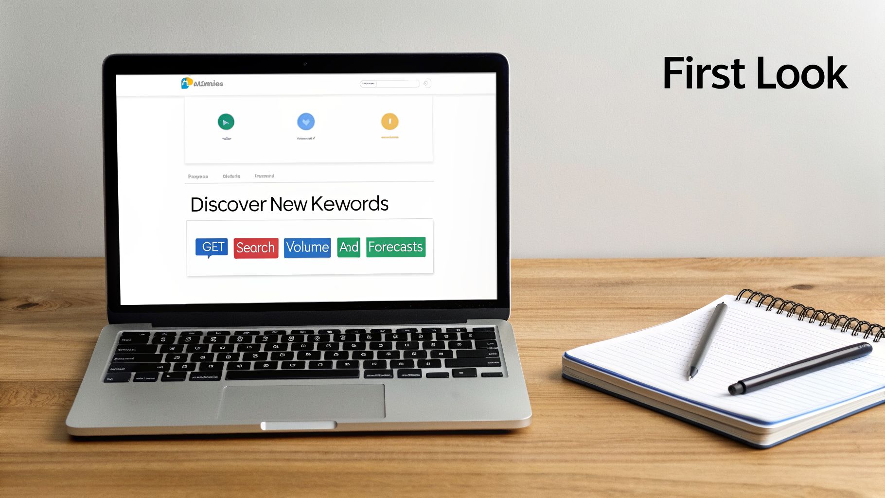 A laptop displaying a keyword research tool with 'Discover New Keywords' and related buttons, alongside a notebook and pens on a wooden desk.