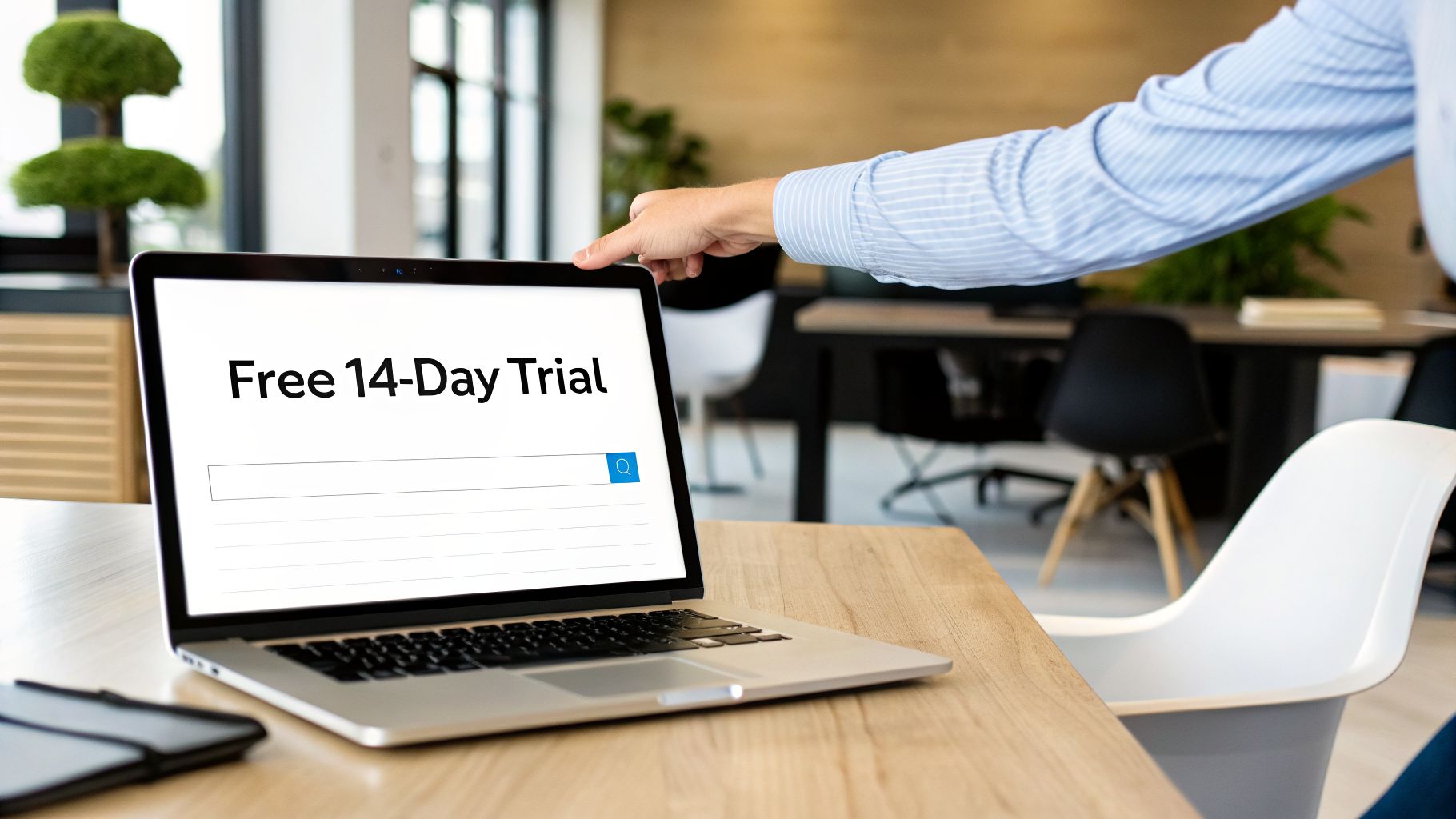 A hand points to a laptop screen displaying 'Free 14-Day Trial' and a search bar in an office.