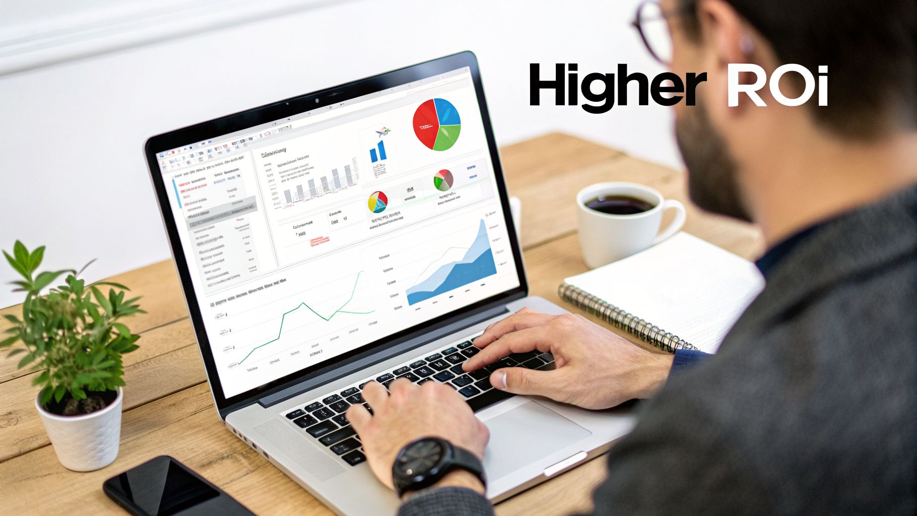 A man analyzing business data and charts on a laptop screen with a coffee cup nearby.
