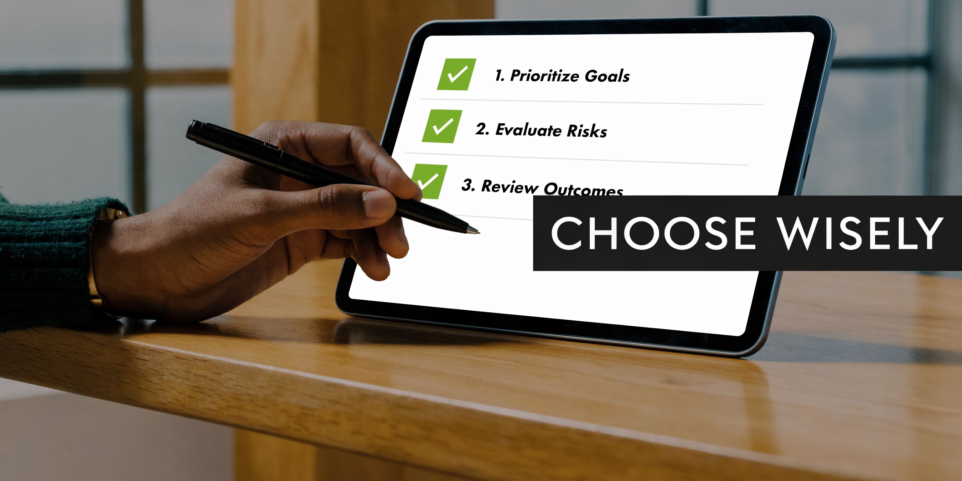 A close-up of a person using a stylus to check off goals on a digital tablet screen.