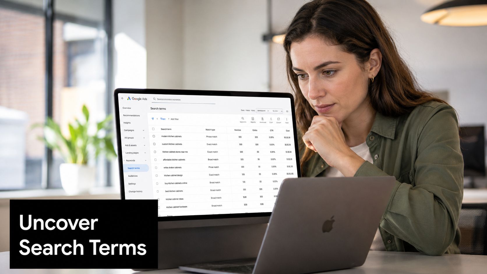 A focused woman analyzing Google Ads search terms on her laptop to optimize her digital advertising campaign.