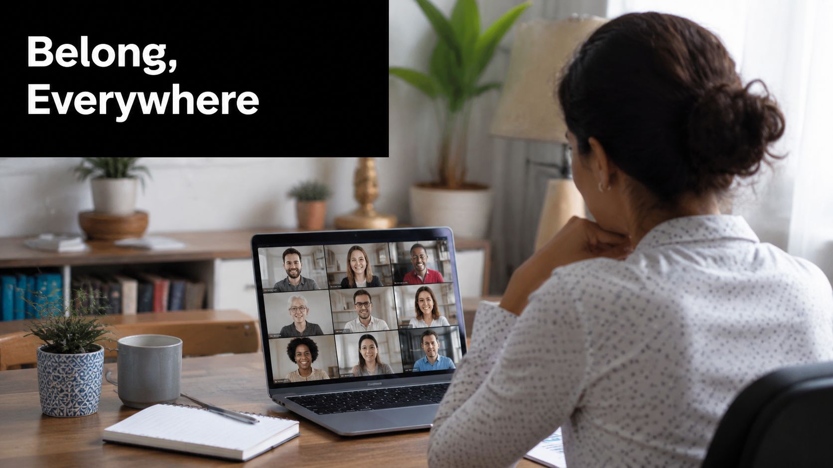 A woman working from home participates in a professional video conference meeting on her laptop computer.