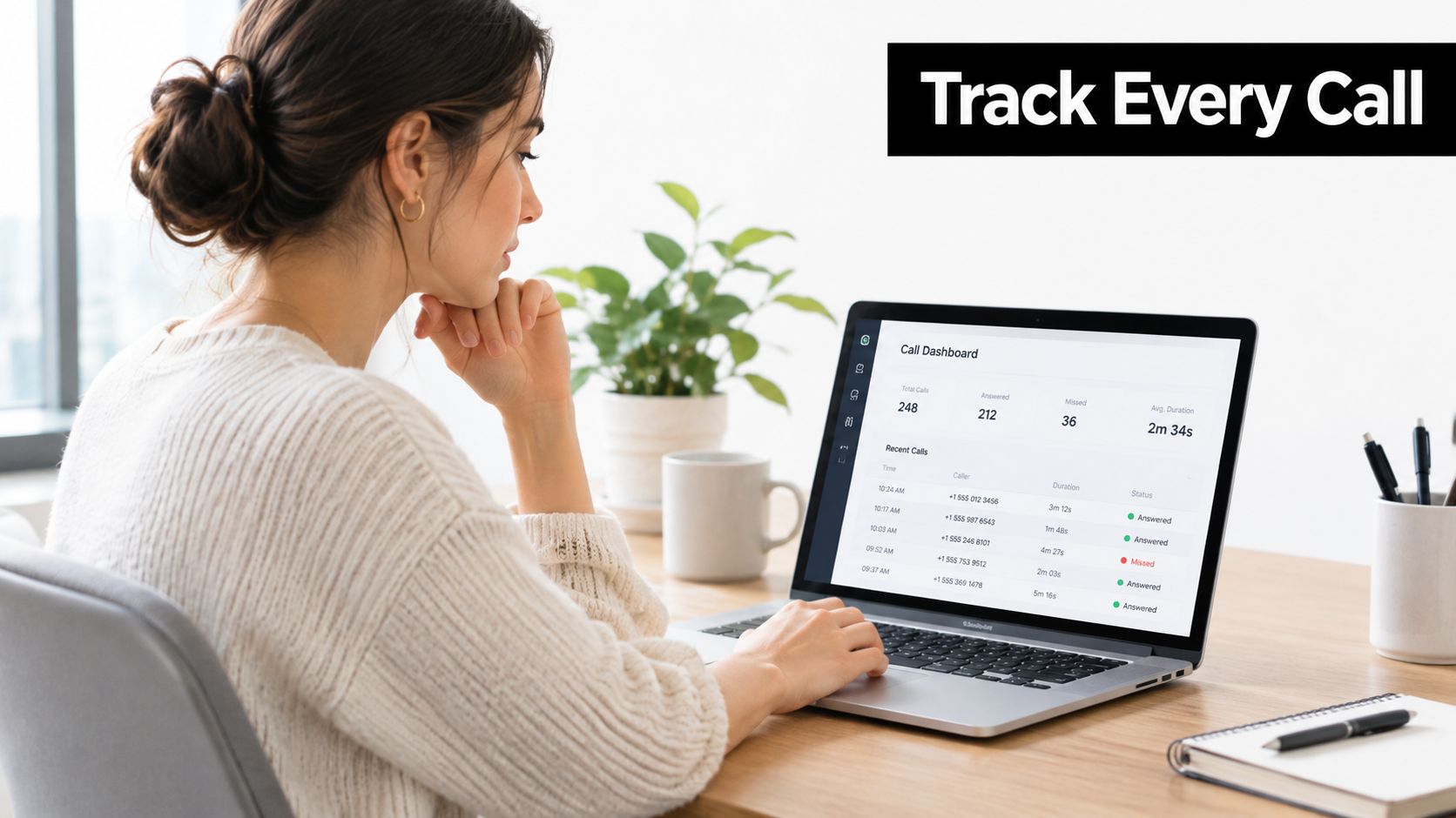 A woman working on a laptop displaying a call tracking dashboard with recent call statistics and statuses.