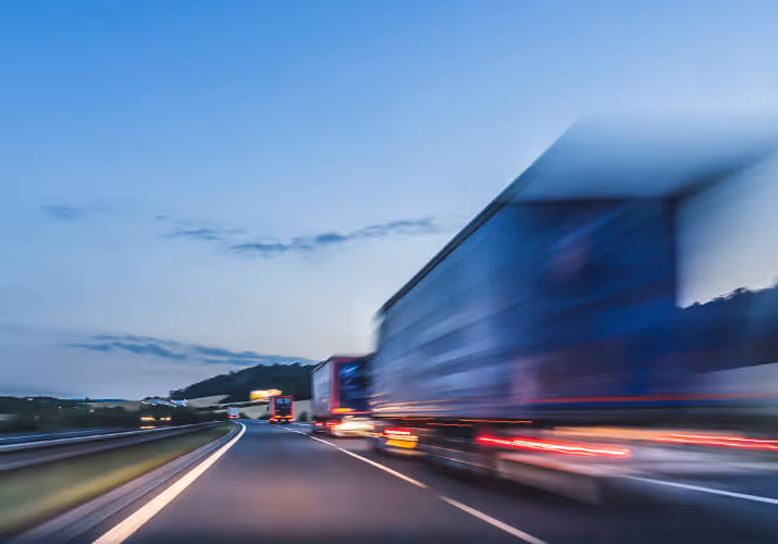 Trucks driving down the expressway.