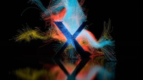 Blue letter X with dynamic colorful light streaks in red, blue, and yellow on a reflective black surface.