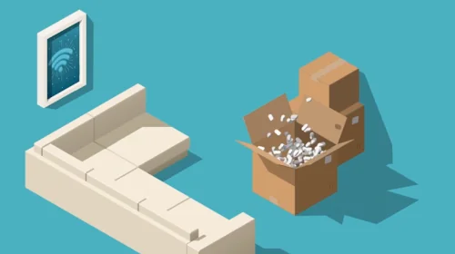 Isometric room with two open moving boxes filled with packing peanuts pop open as devices jump into place on the wall and table.