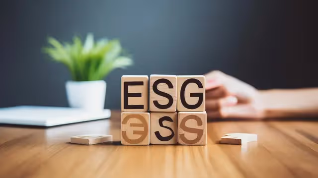 Business leaders strategizing on ESG goals and risk management in a boardroom setting.